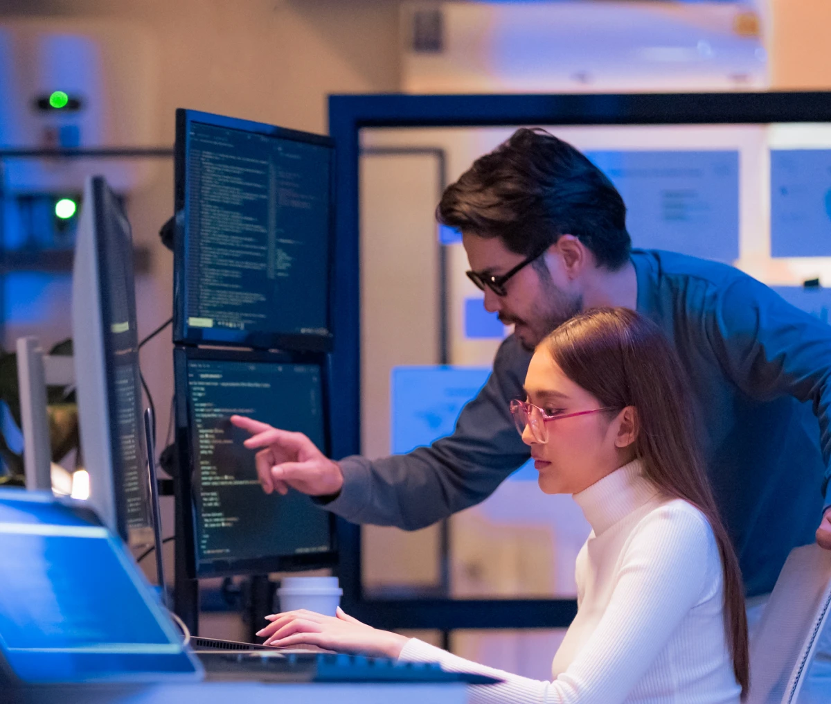 Coworkers collaborating on computer screens